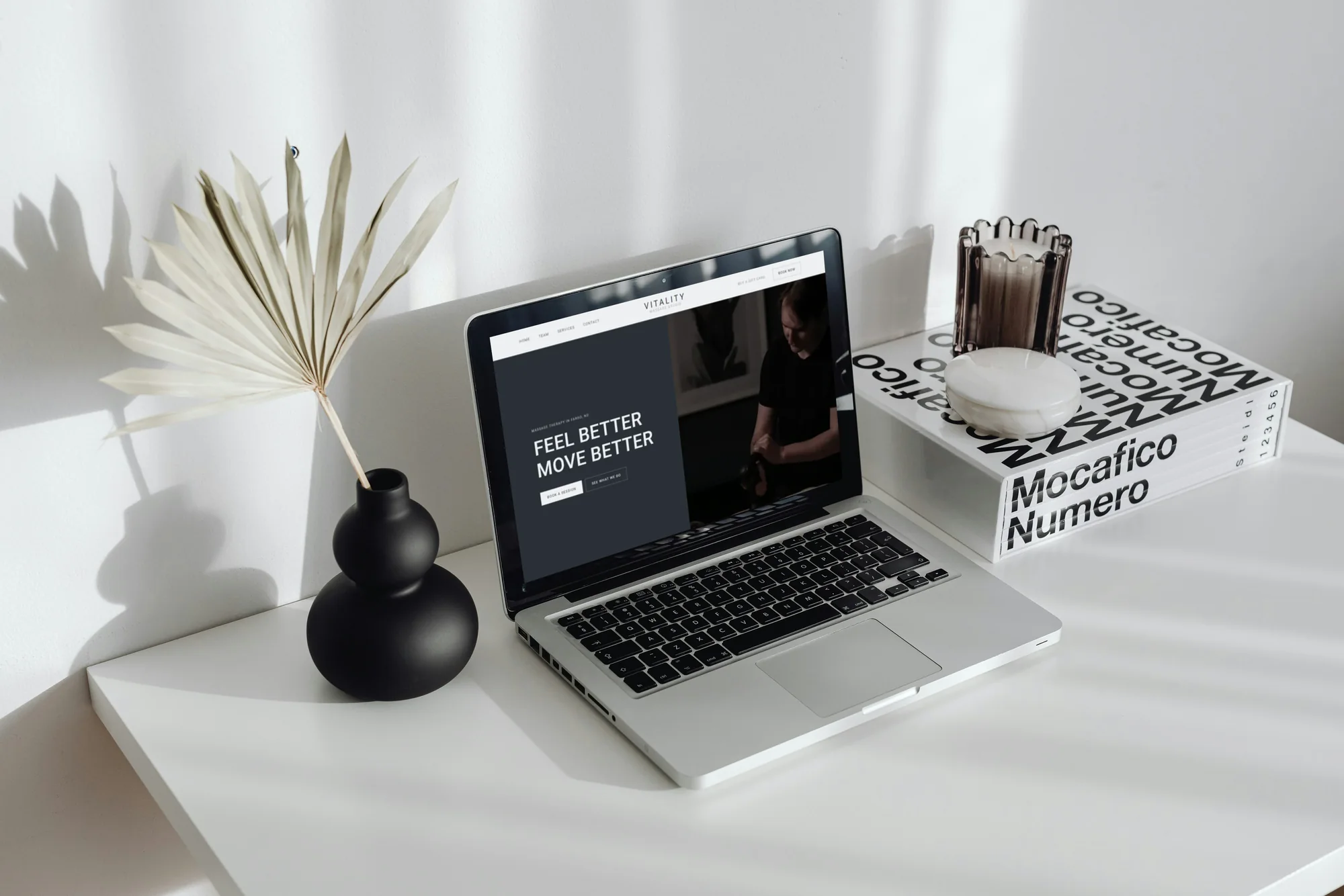 The Vitality Massage Studio home page open on a laptop